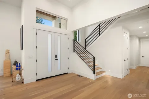 a view of a livingroom with wooden floor and stairs