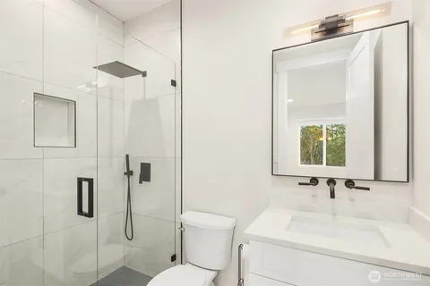 a bathroom with a sink toilet and shower