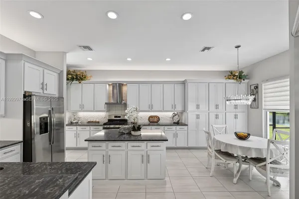 a kitchen with center island and windows