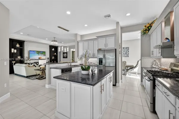 a view of a dining room with furniture and chandelier