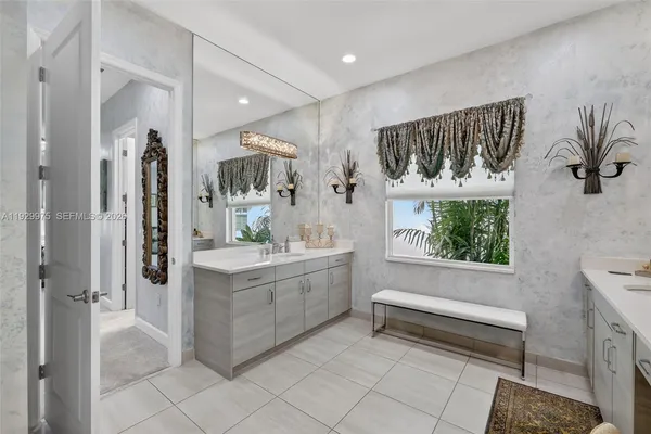 a bathroom with a granite countertop sink a toilet and a mirror