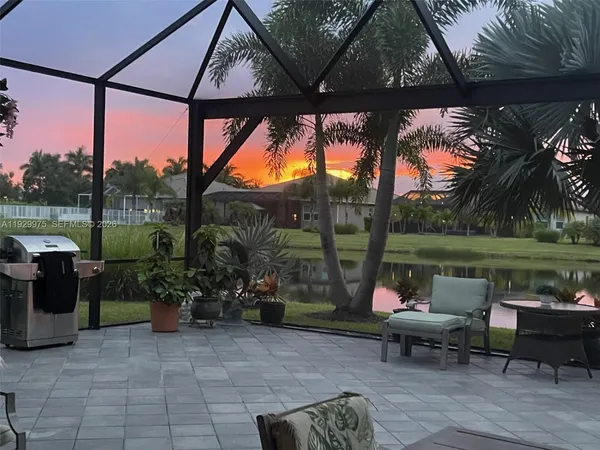 a backyard of a house with lake view and a potted plant