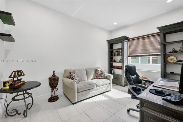 a view of a patio with table and chairs under an umbrella