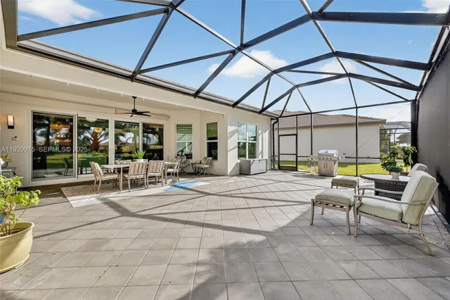 a backyard of a house with lots of green space and lake view in back