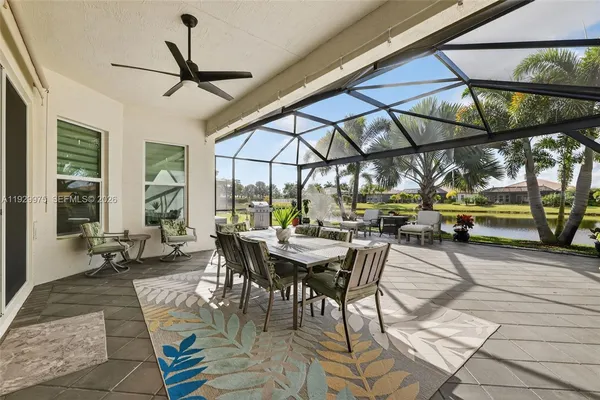 a backyard of a house with lots of green space and lake view in back