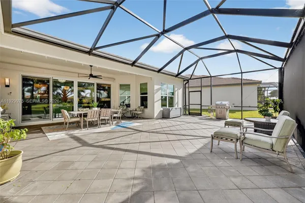 a view of a house with a yard and sitting area