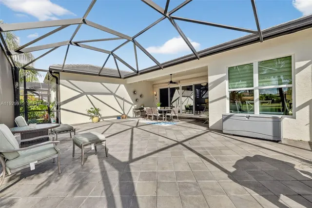 a front view of a house with a garden and lake view