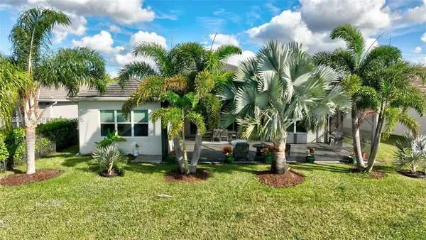 a large living room with stainless steel appliances granite countertop furniture and a wooden floor