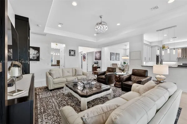 a living room with furniture or chandelier and a flat screen tv