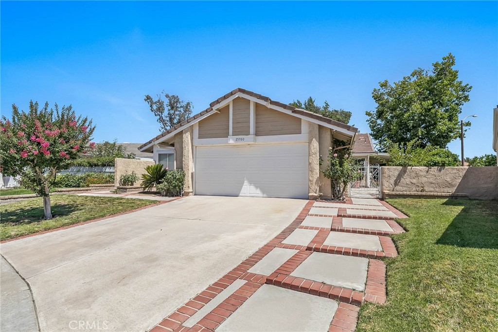 25760 Rancho Adobe Road Valencia, CA 91355 - Photo 1 of 1 a front view of a house with a yard and potted plants