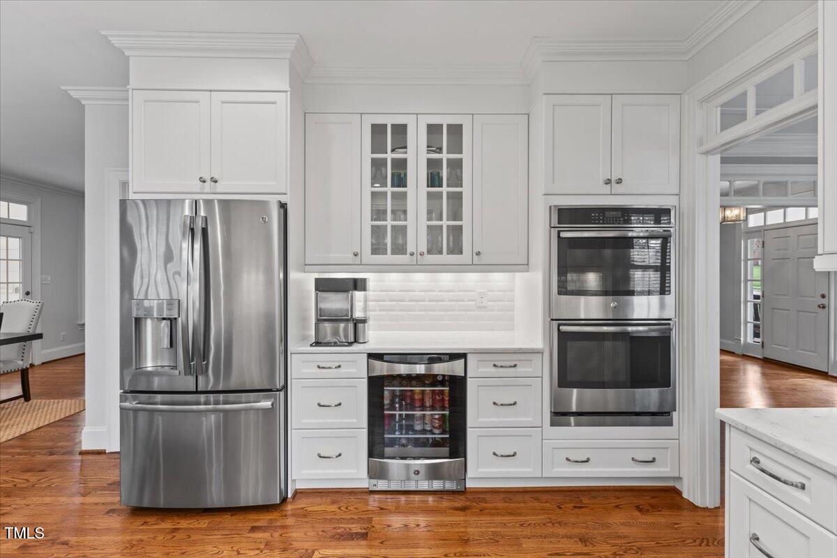 6116 Wilkinsburg Road Raleigh, NC 27612 - Photo 16 of 65 a kitchen with stainless steel appliances a refrigerator and a stove top oven