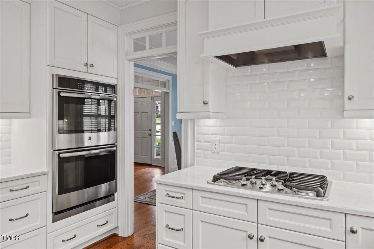 6116 Wilkinsburg Road Raleigh, NC 27612 - Photo 19 of 65 a stove top oven sitting inside of a kitchen