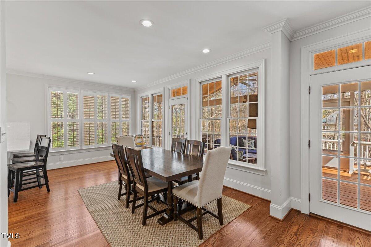 6116 Wilkinsburg Road Raleigh, NC 27612 - Photo 21 of 65 a view of a dining room with furniture window and wooden floor