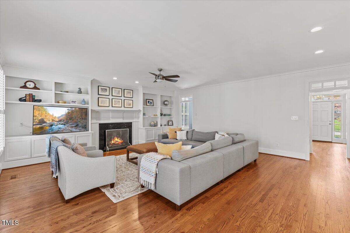 6116 Wilkinsburg Road Raleigh, NC 27612 - Photo 22 of 65 a living room with furniture and a fireplace