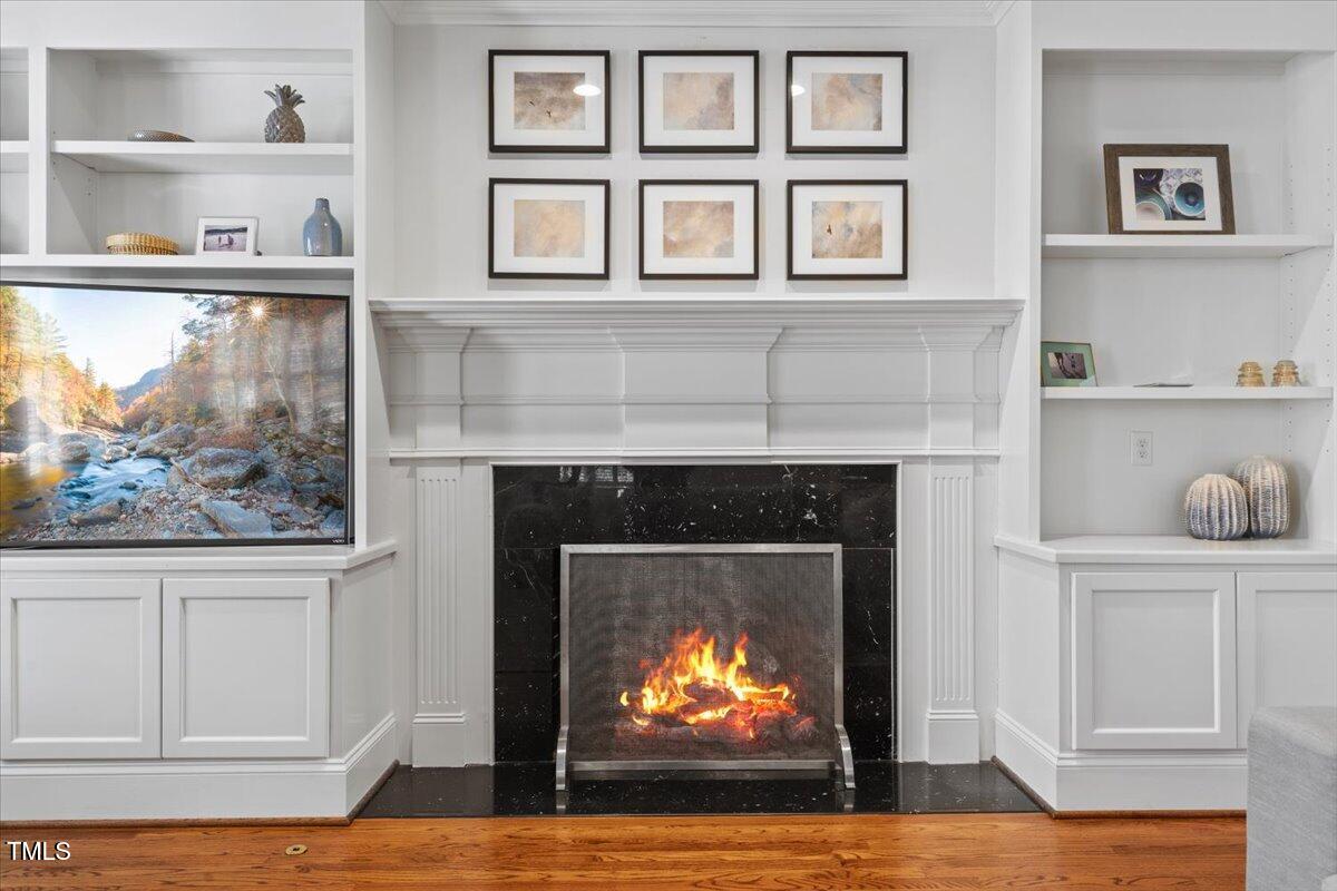 6116 Wilkinsburg Road Raleigh, NC 27612 - Photo 24 of 65 a living room with fireplace and a wooden floor