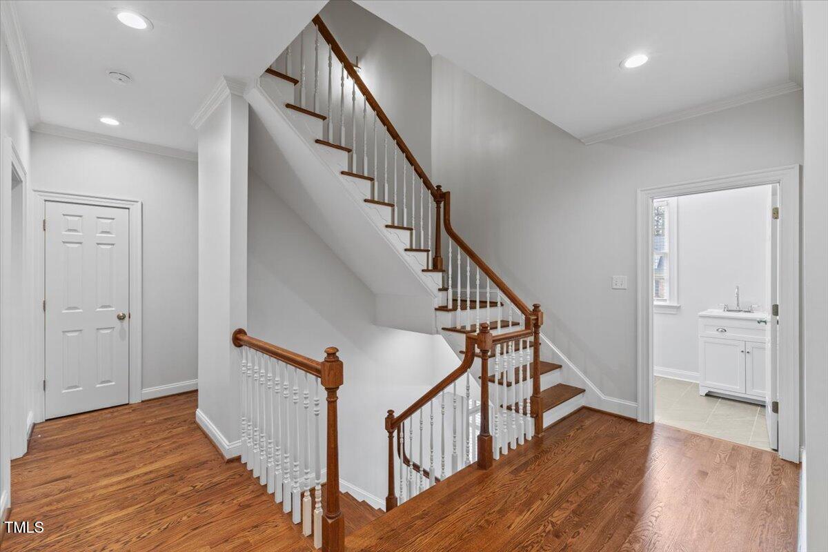 6116 Wilkinsburg Road Raleigh, NC 27612 - Photo 26 of 65 a view of staircase with wooden floor and white walls