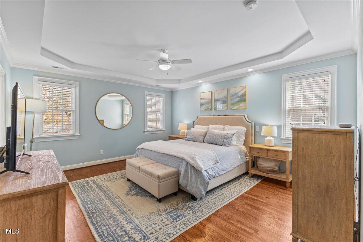 6116 Wilkinsburg Road Raleigh, NC 27612 - Photo 27 of 65 a bedroom with a large bed and wooden floor