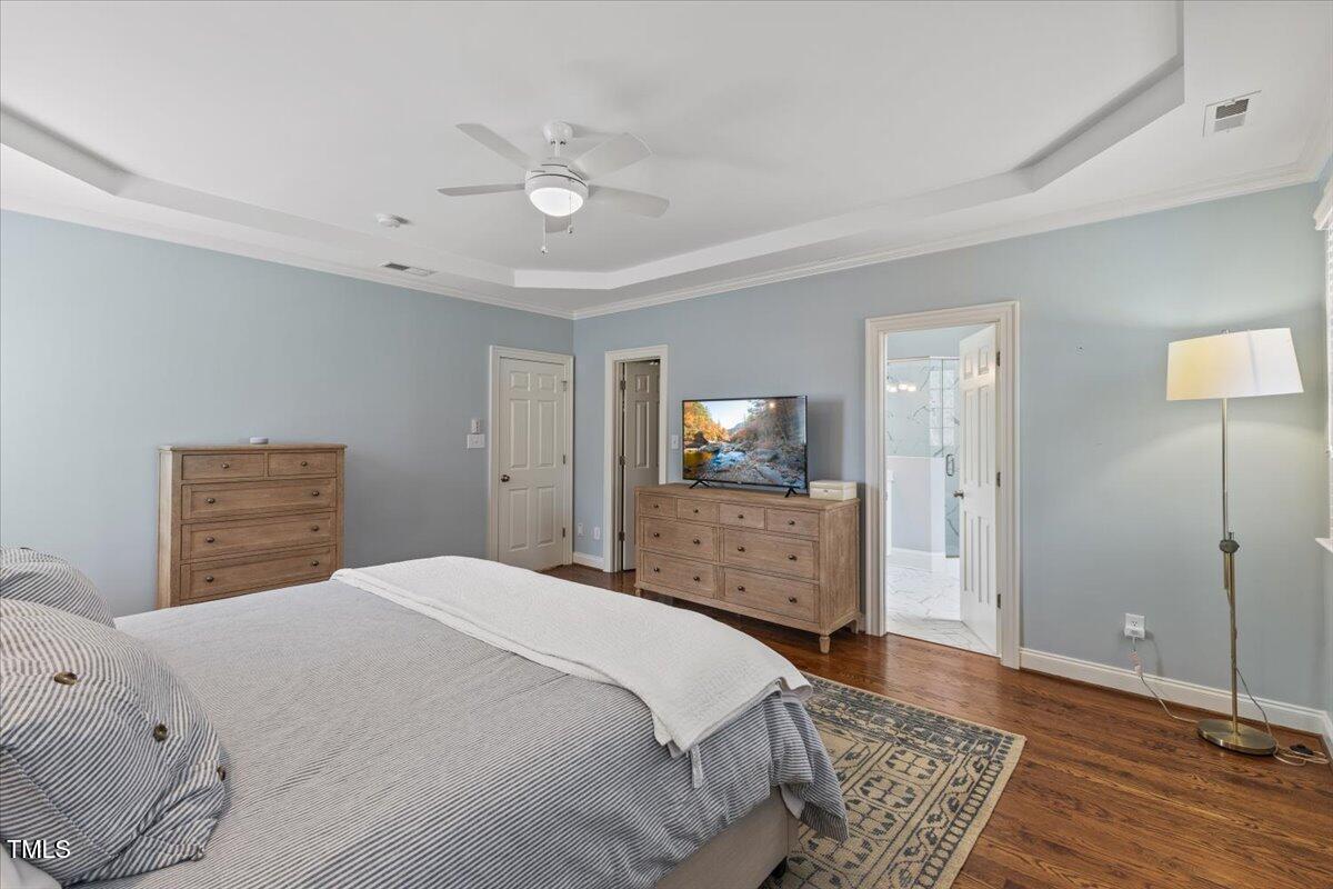 6116 Wilkinsburg Road Raleigh, NC 27612 - Photo 29 of 65 a bedroom with a bed and wooden floor