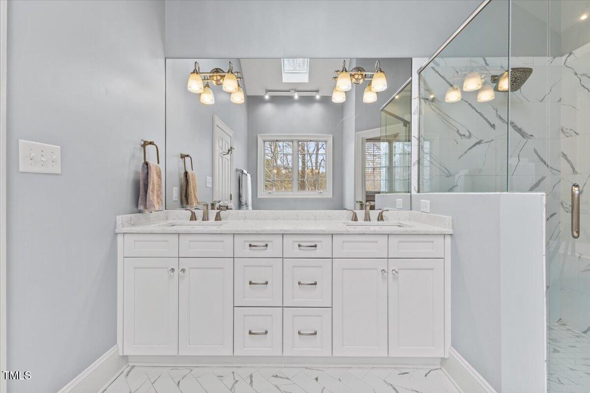 6116 Wilkinsburg Road Raleigh, NC 27612 - Photo 31 of 65 a bathroom with a sink vanity and a mirror
