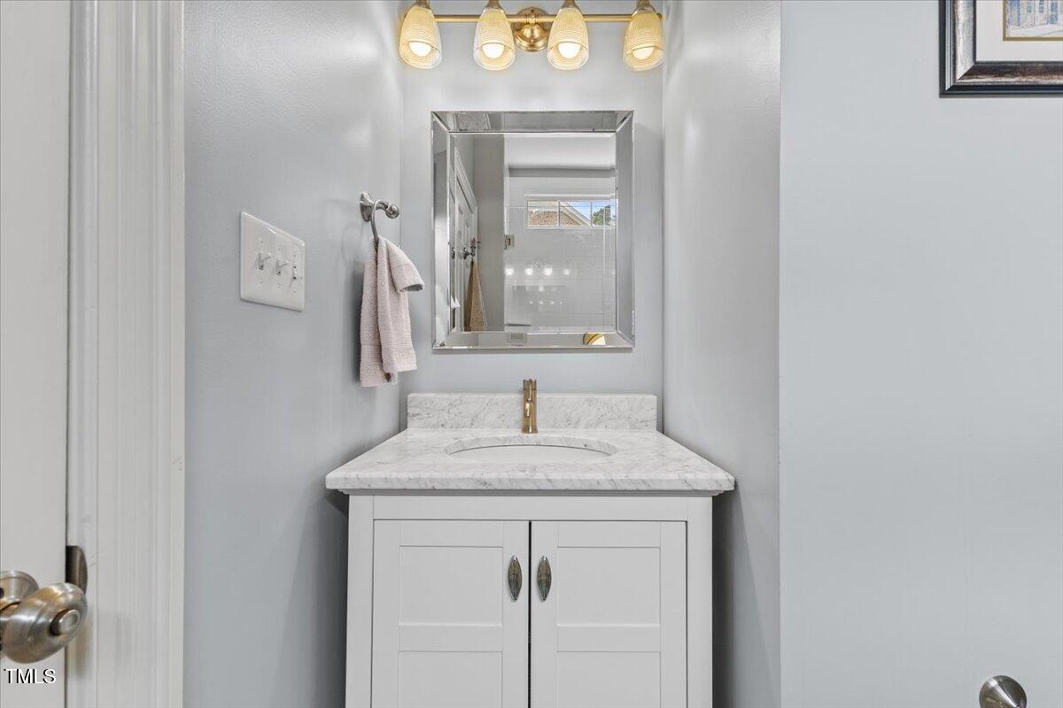6116 Wilkinsburg Road Raleigh, NC 27612 - Photo 36 of 65 a bathroom with a sink and a mirror