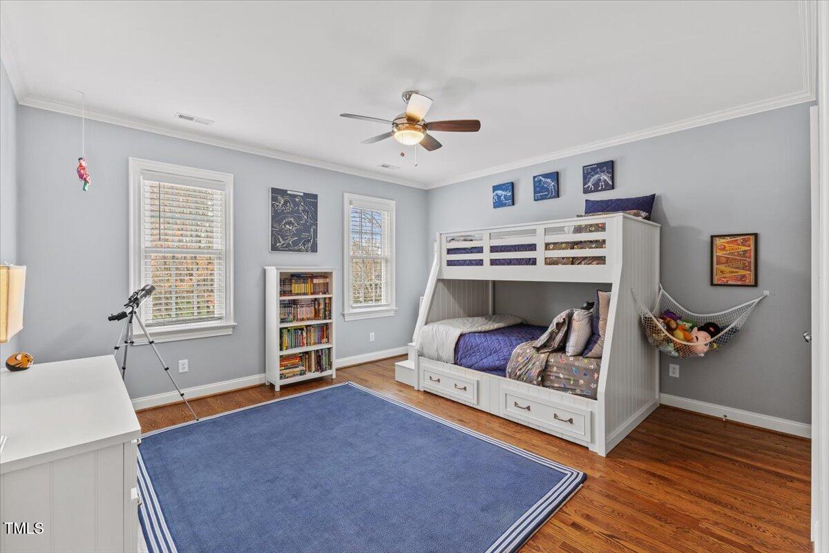 6116 Wilkinsburg Road Raleigh, NC 27612 - Photo 38 of 65 a living room with furniture and a book shelf
