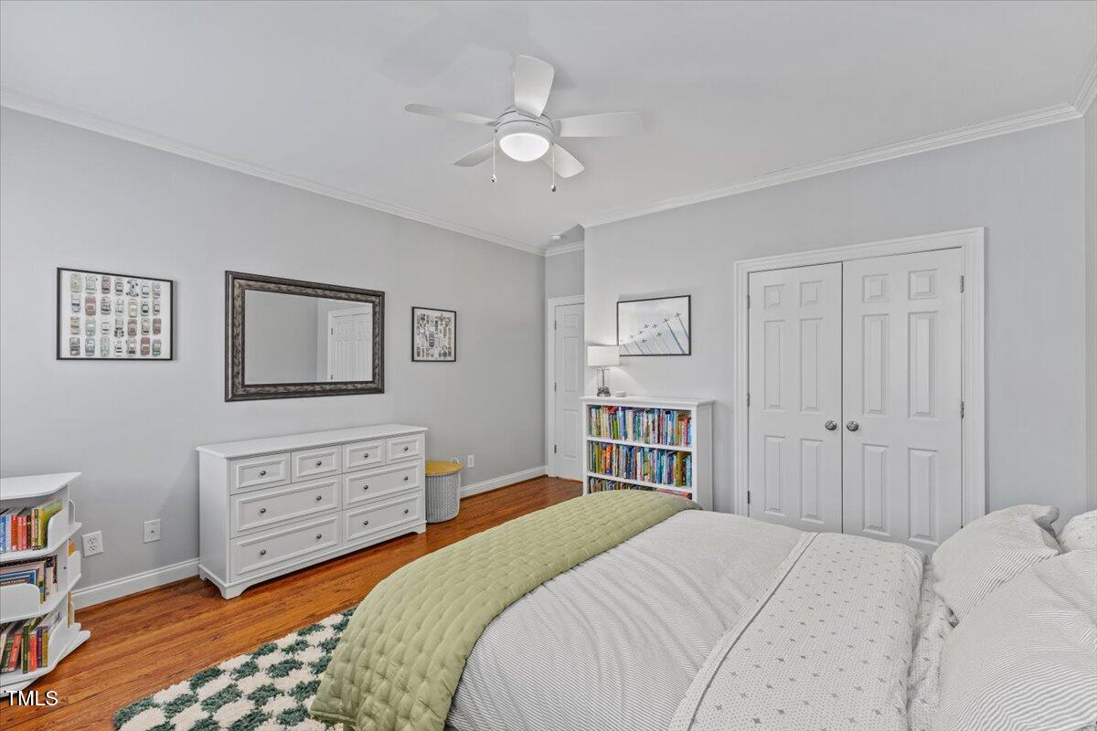 6116 Wilkinsburg Road Raleigh, NC 27612 - Photo 42 of 65 a bedroom with a bed and a chandelier