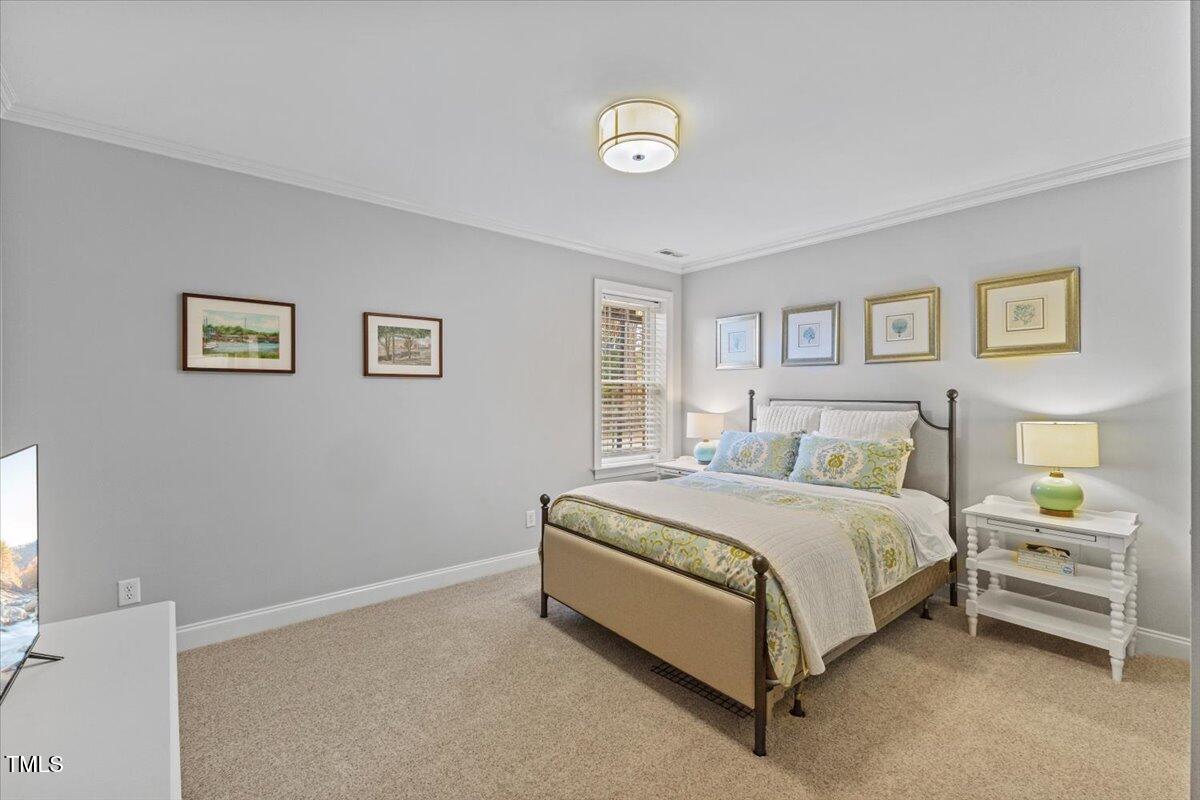 6116 Wilkinsburg Road Raleigh, NC 27612 - Photo 45 of 65 a spacious bedroom with a bed and wall painting