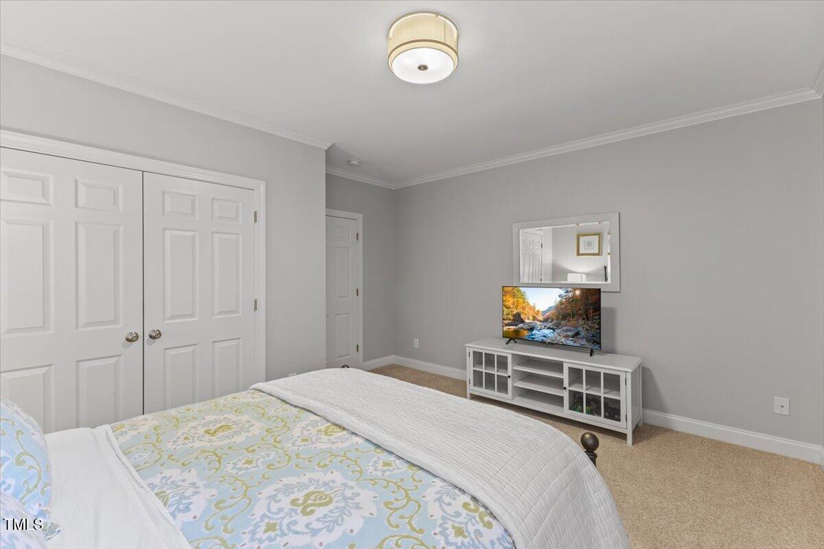 6116 Wilkinsburg Road Raleigh, NC 27612 - Photo 46 of 65 a bedroom with a bed and a television