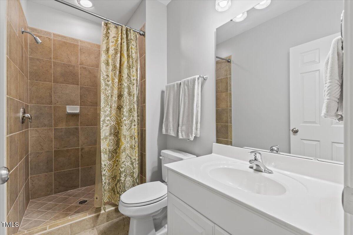 6116 Wilkinsburg Road Raleigh, NC 27612 - Photo 47 of 65 a bathroom with a sink toilet and shower