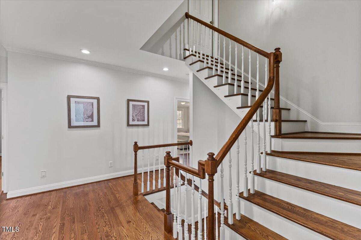 6116 Wilkinsburg Road Raleigh, NC 27612 - Photo 50 of 65 a view of staircase with wooden floor and white walls