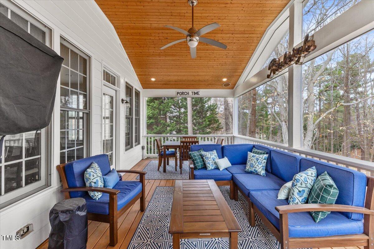 6116 Wilkinsburg Road Raleigh, NC 27612 - Photo 53 of 65 a living room with furniture and floor to ceiling windows