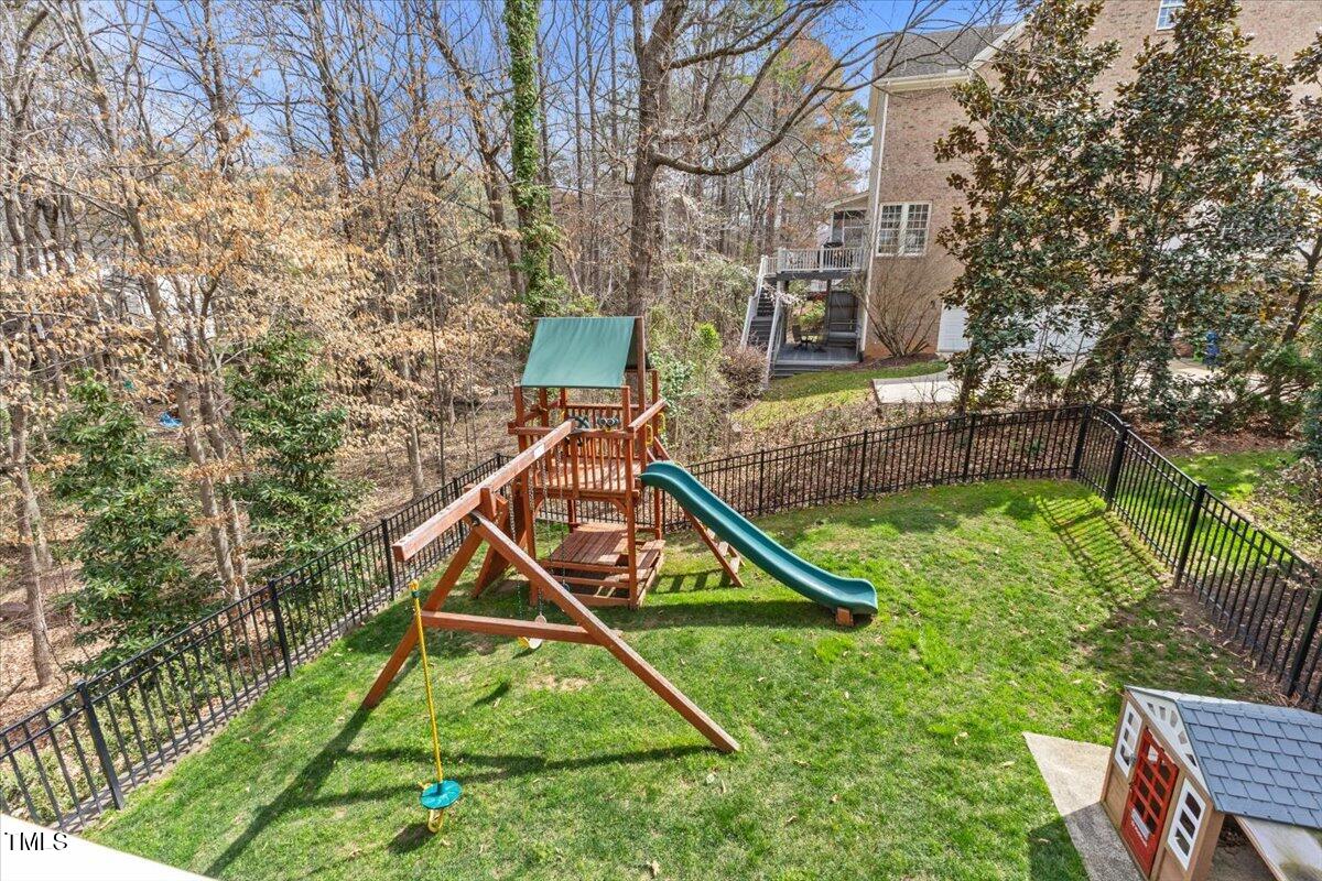 6116 Wilkinsburg Road Raleigh, NC 27612 - Photo 56 of 65 a view of a house with a backyard