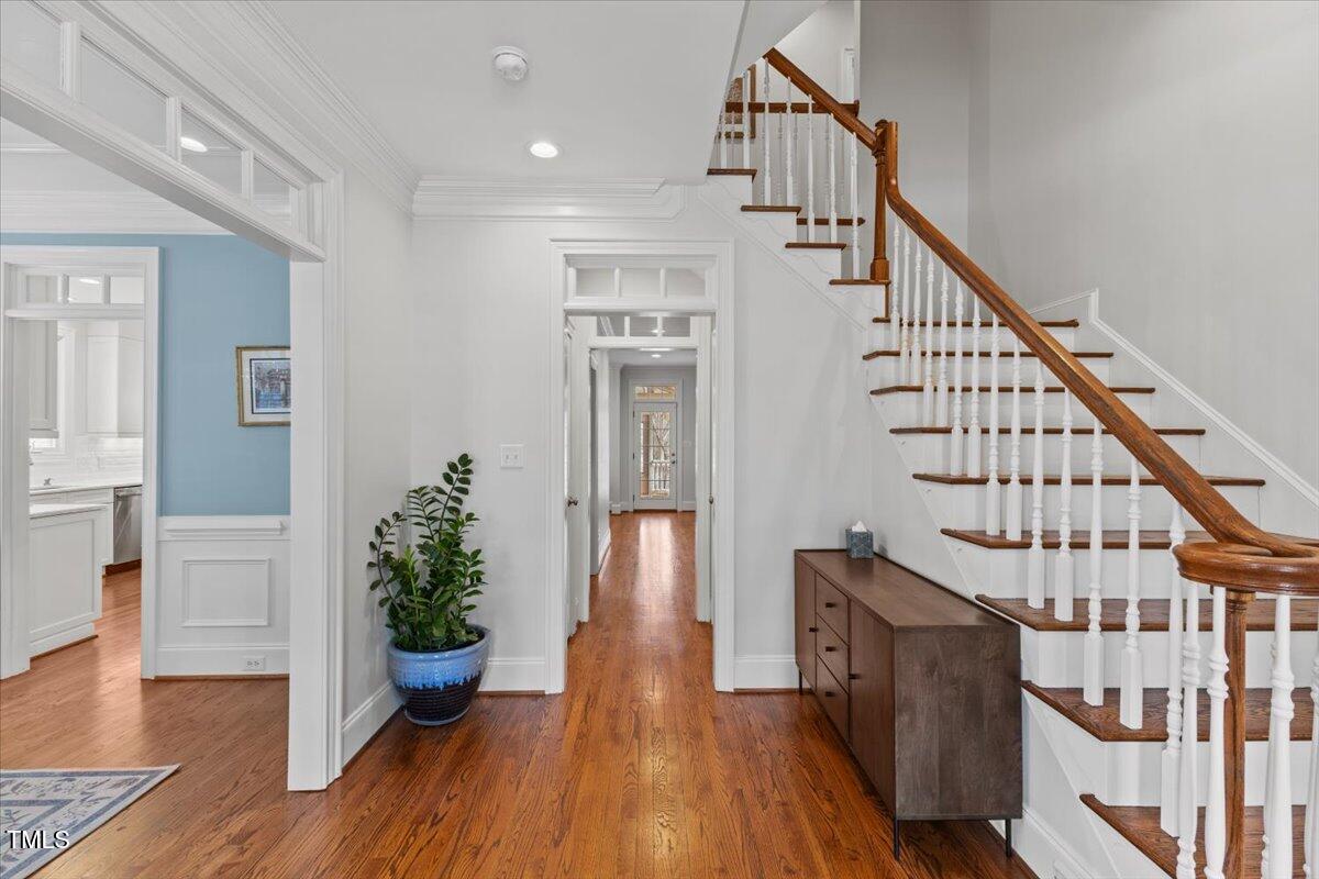 6116 Wilkinsburg Road Raleigh, NC 27612 - Photo 6 of 65 a view of entryway with wooden floor and stairs