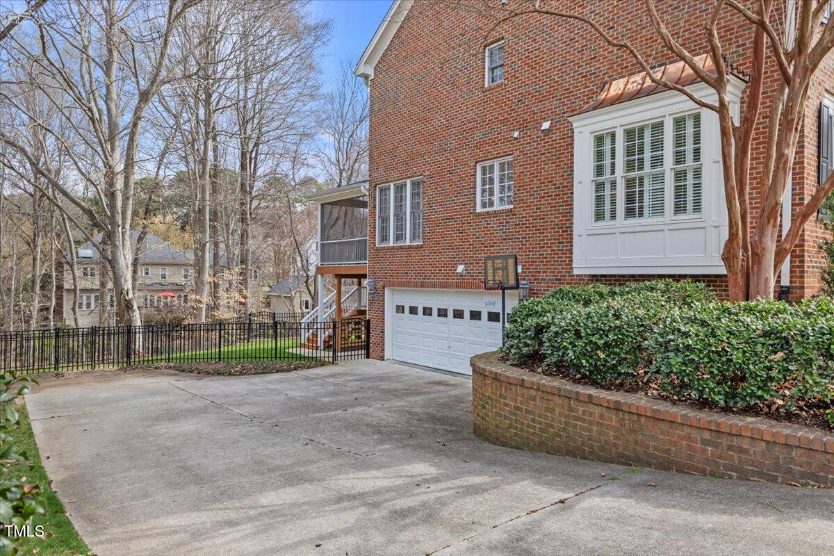 6116 Wilkinsburg Road Raleigh, NC 27612 - Photo 61 of 65 a view of a house with a yard and potted plants
