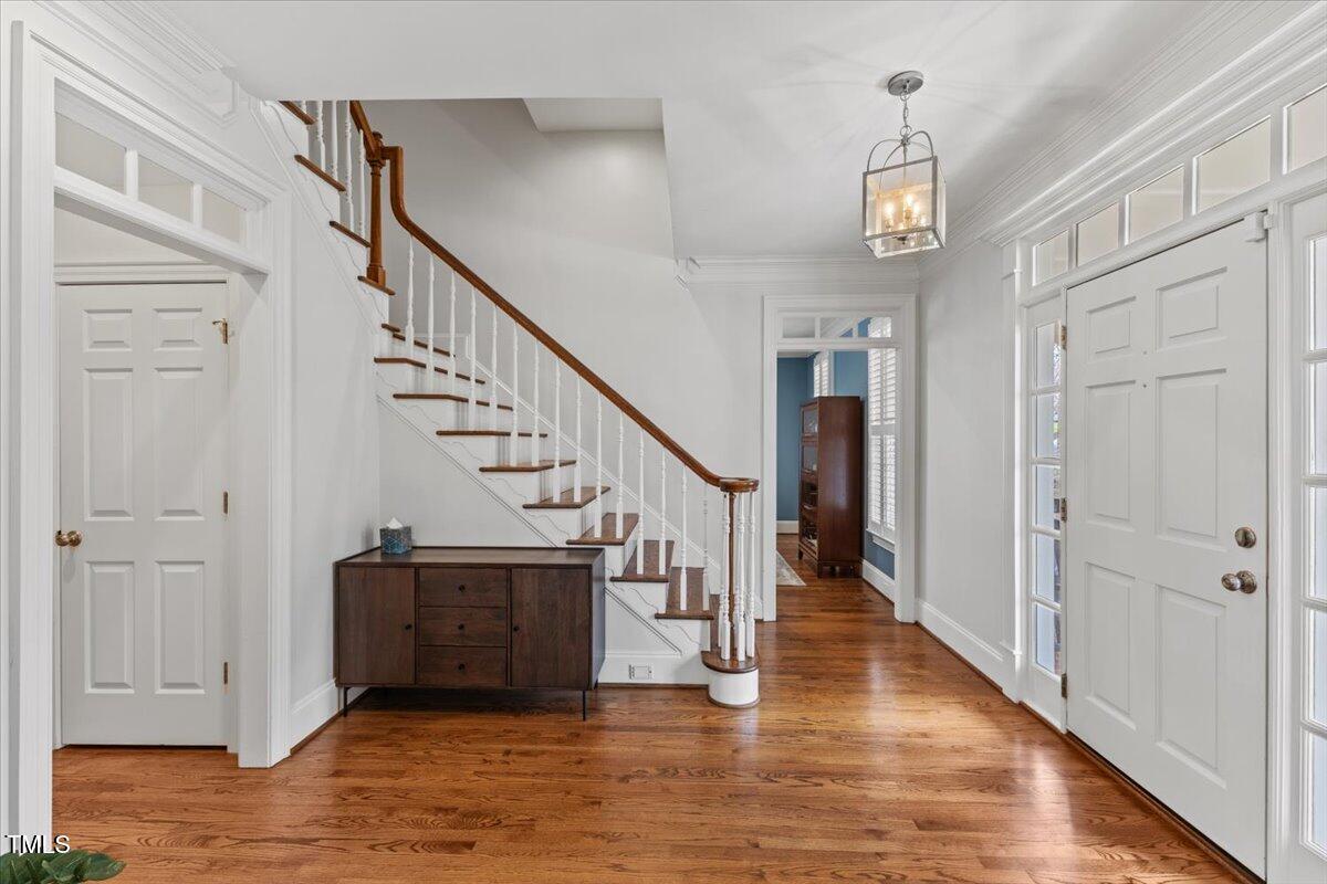 6116 Wilkinsburg Road Raleigh, NC 27612 - Photo 7 of 65 a view of entryway and hall with wooden floor