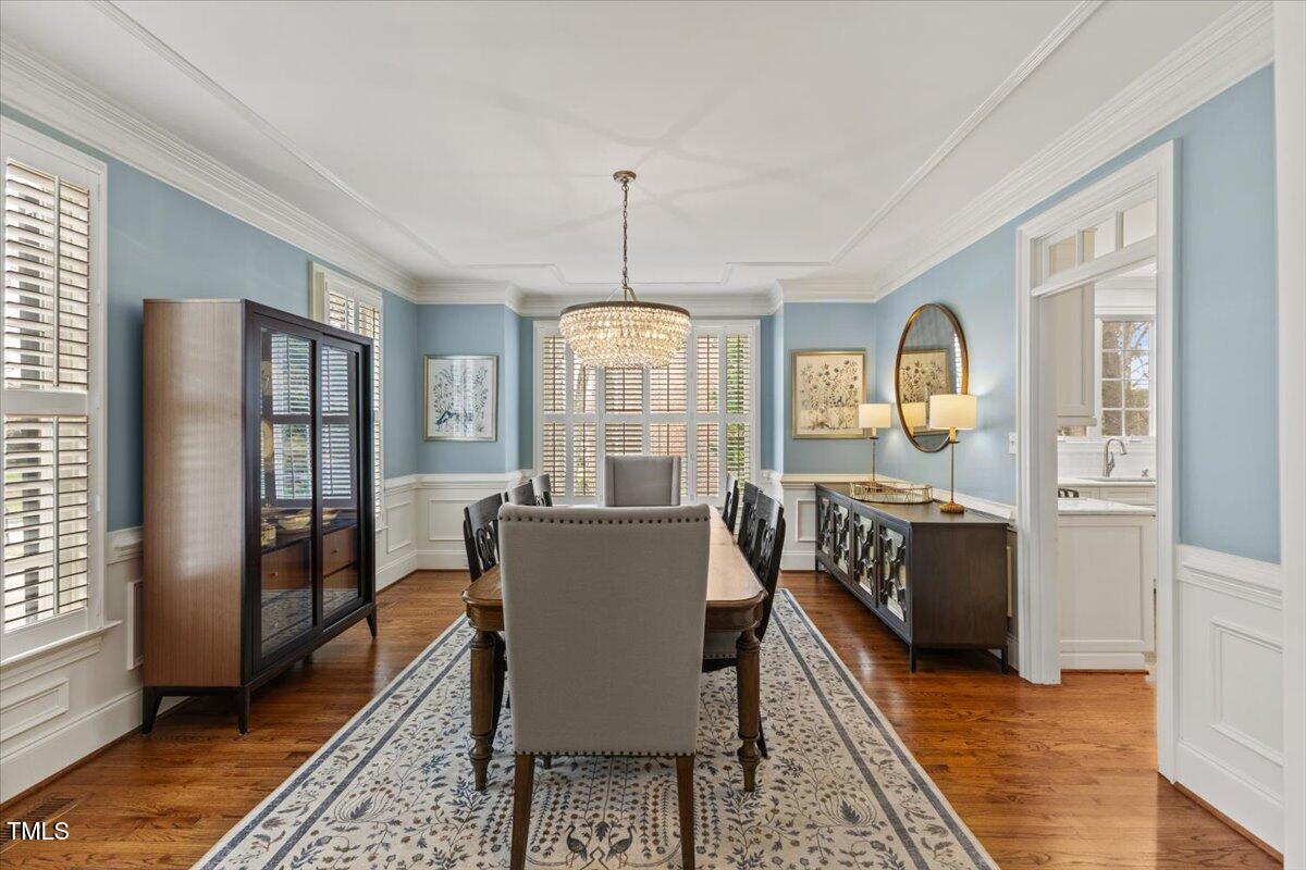 6116 Wilkinsburg Road Raleigh, NC 27612 - Photo 9 of 65 a view of a dining room with furniture window and wooden floor