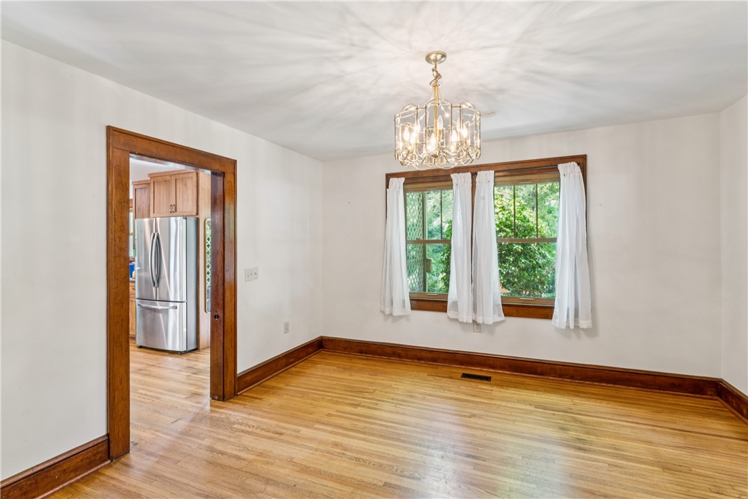 321 South Pine Street Walhalla, SC 29691 - Photo 6 of 32 Bright hardwood floors and a modern chandelier illuminate this versatile space, perfect for dining or an office.