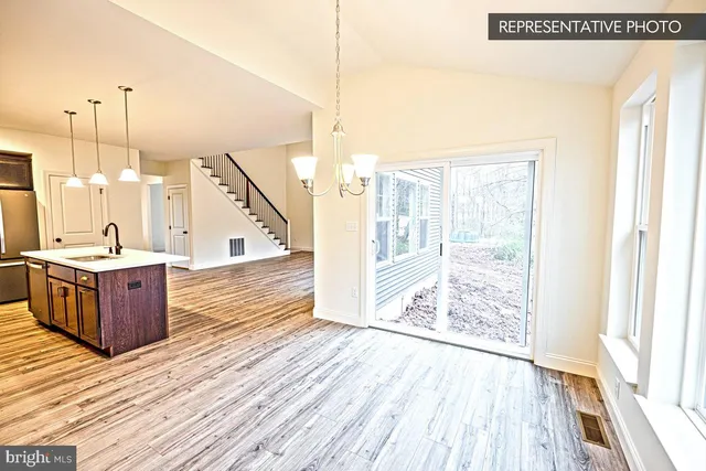 a view of a living room with wooden floor
