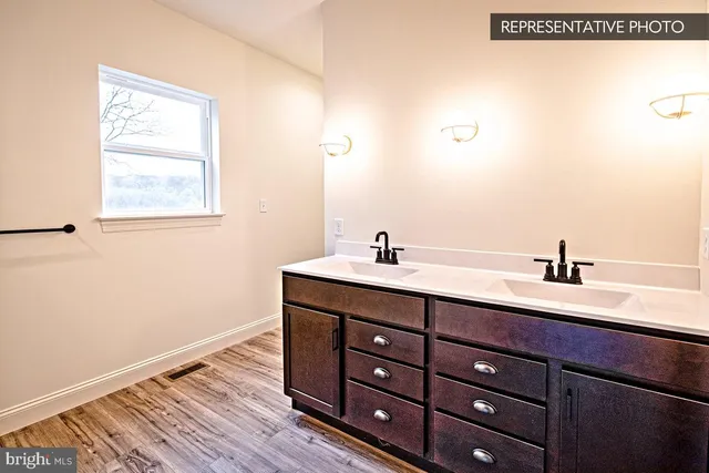 a bathroom with a double vanity sink and mirror