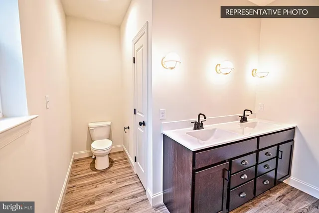 a bathroom with a sink toilet and a mirror
