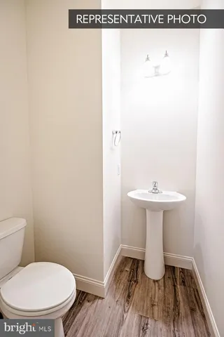 a bathroom with a sink toilet and a mirror