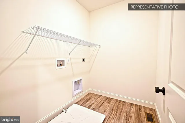 a view of a closet with wooden floor