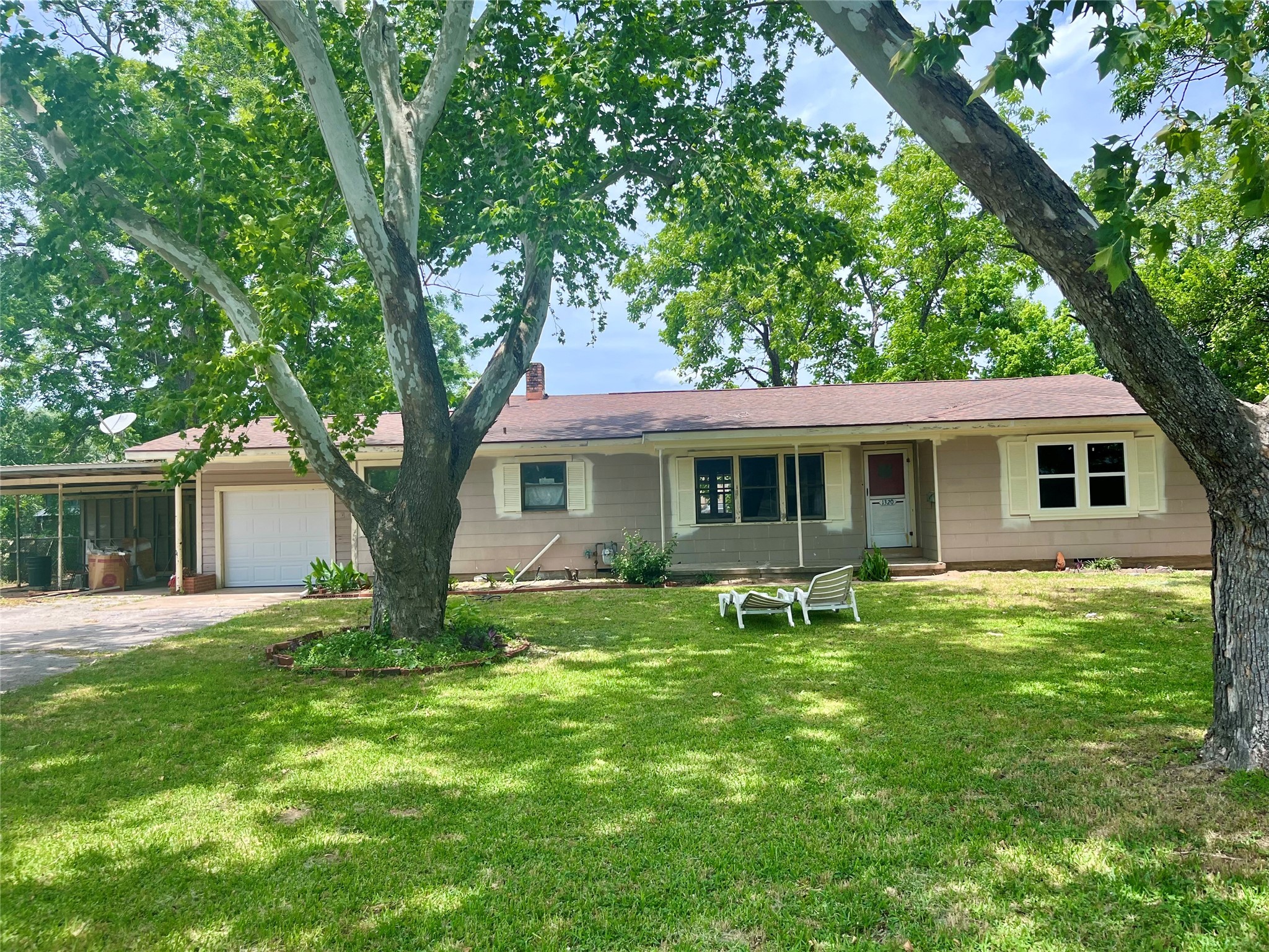 a backyard of a house with table and chairs