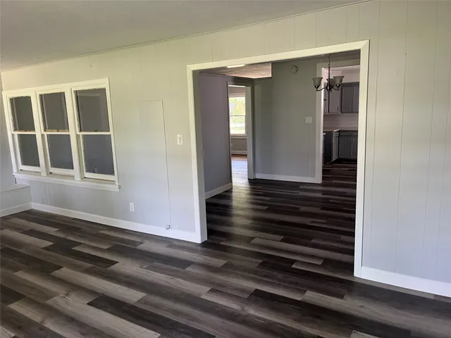a view of a closet area with wooden floor