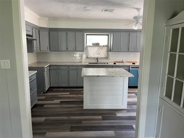 a kitchen with cabinets appliances and a counter space
