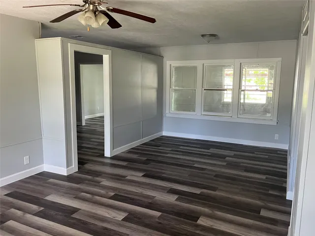 a view of wooden floor and windows in a room