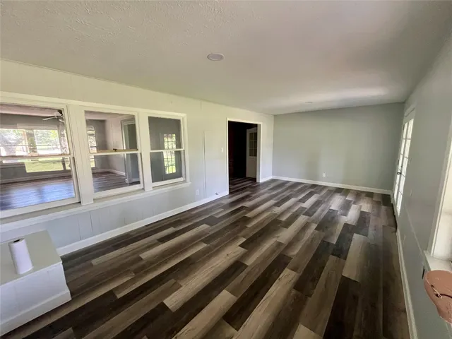 a view of a room with wooden floor