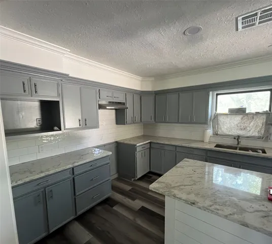a kitchen with a sink stove and microwave