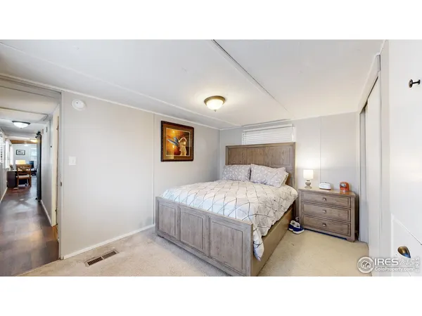 a living room with a bed furniture and a window