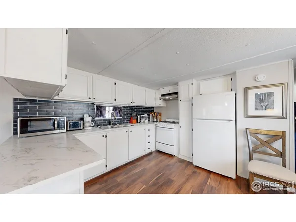 a open kitchen with cabinets stainless steel appliances and wooden floor